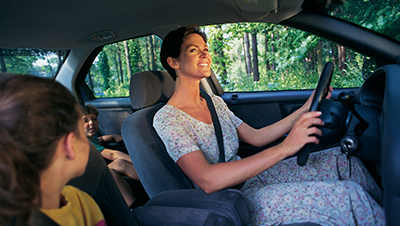 a group of people sitting on the seat of a car